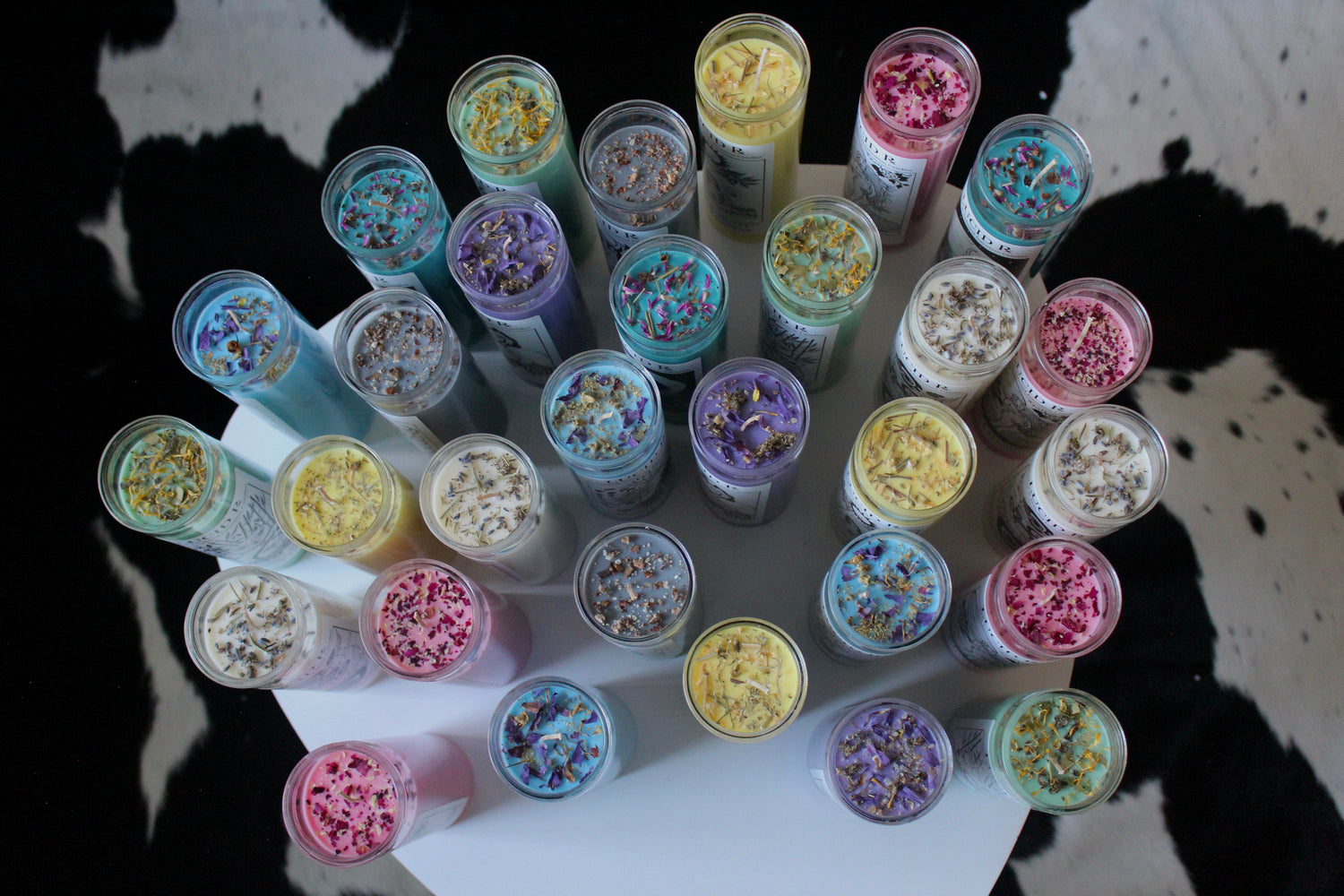 Colorful, tall prayer candles infused with essential oils and botanicals